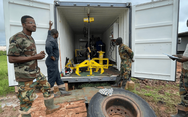 Military personnel operating containerized run-flat workshop at forward operating base