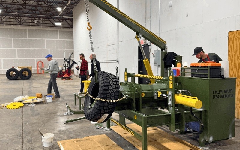 GM Defensive Workshop model run-flat tire changing machine in operation with military tire